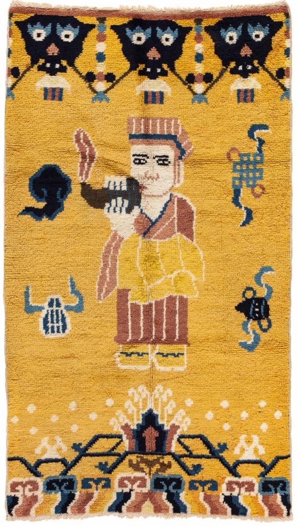 'Robed Lama blows conch' Wool Yellow Pillar Pictorial Rug (one of pair)