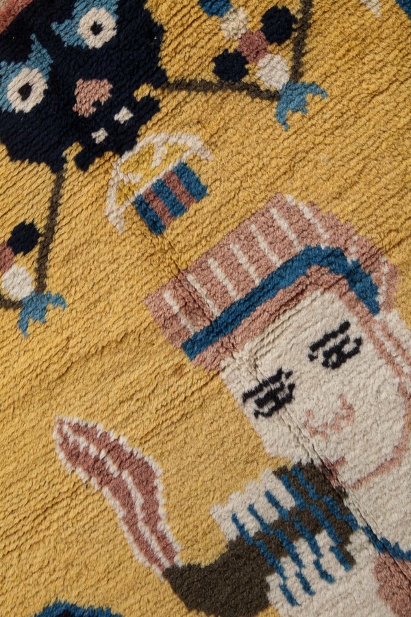 'Robed Lama blows conch' Tibet Buddhist Pillar Pictorial Rug (one of pair) at Essie Carpets, Mayfair London