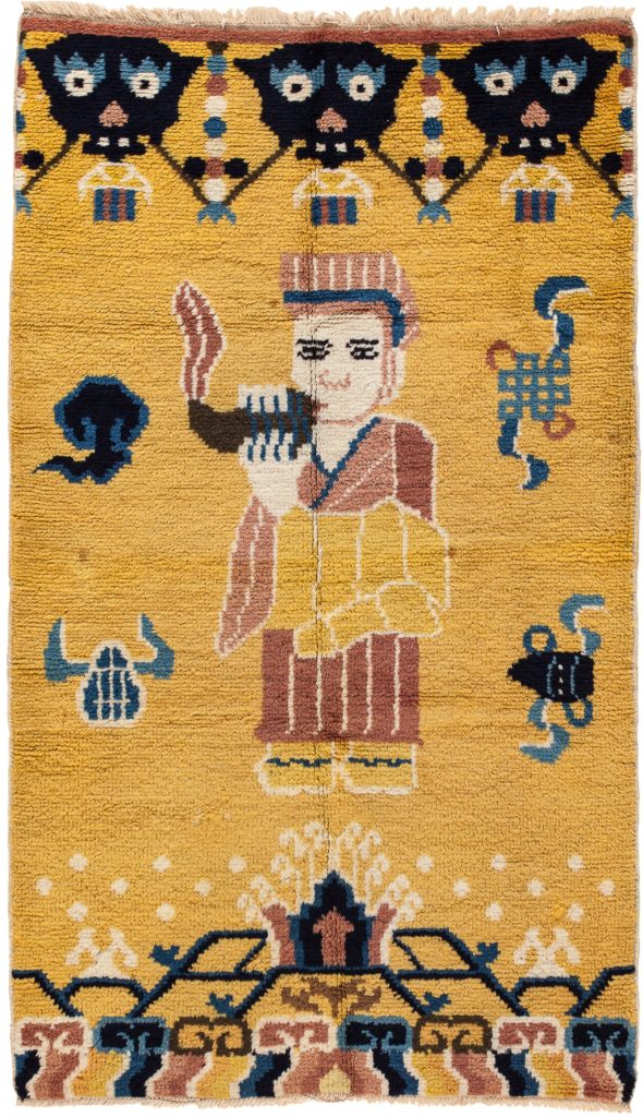 Buddhist Temple Pillar Pictorial Yellow Wool Rug 'Robed Lama blows conch in call to prayer' Early 20th Century 1.5x1m (5x3ft Standard Area Size)