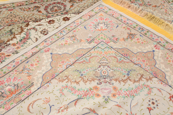 Fine Pure Silk Persian Tabriz Rug - Central Medallion - Light complexion on pistachio green coloured base complemented by blue, pink and ivory accents