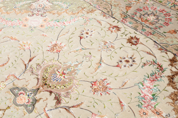 Fine Pure Silk Persian Tabriz Rug - Central Medallion - Light complexion on pistachio green coloured base complemented by blue, pink and ivory accents